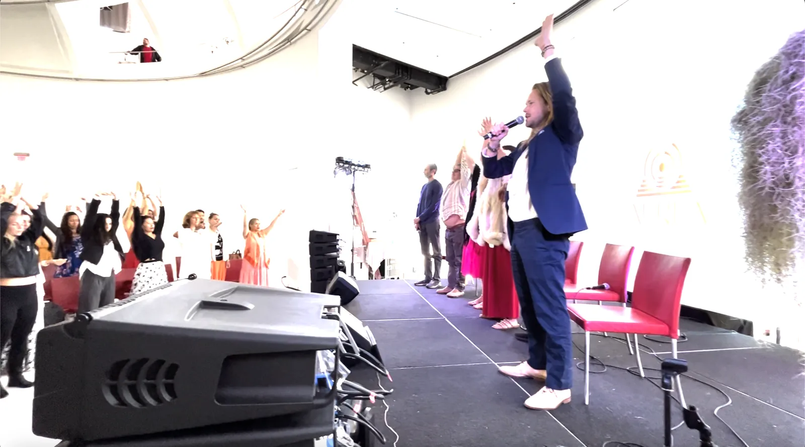 Jeff on stage with the whole room's hands in the air