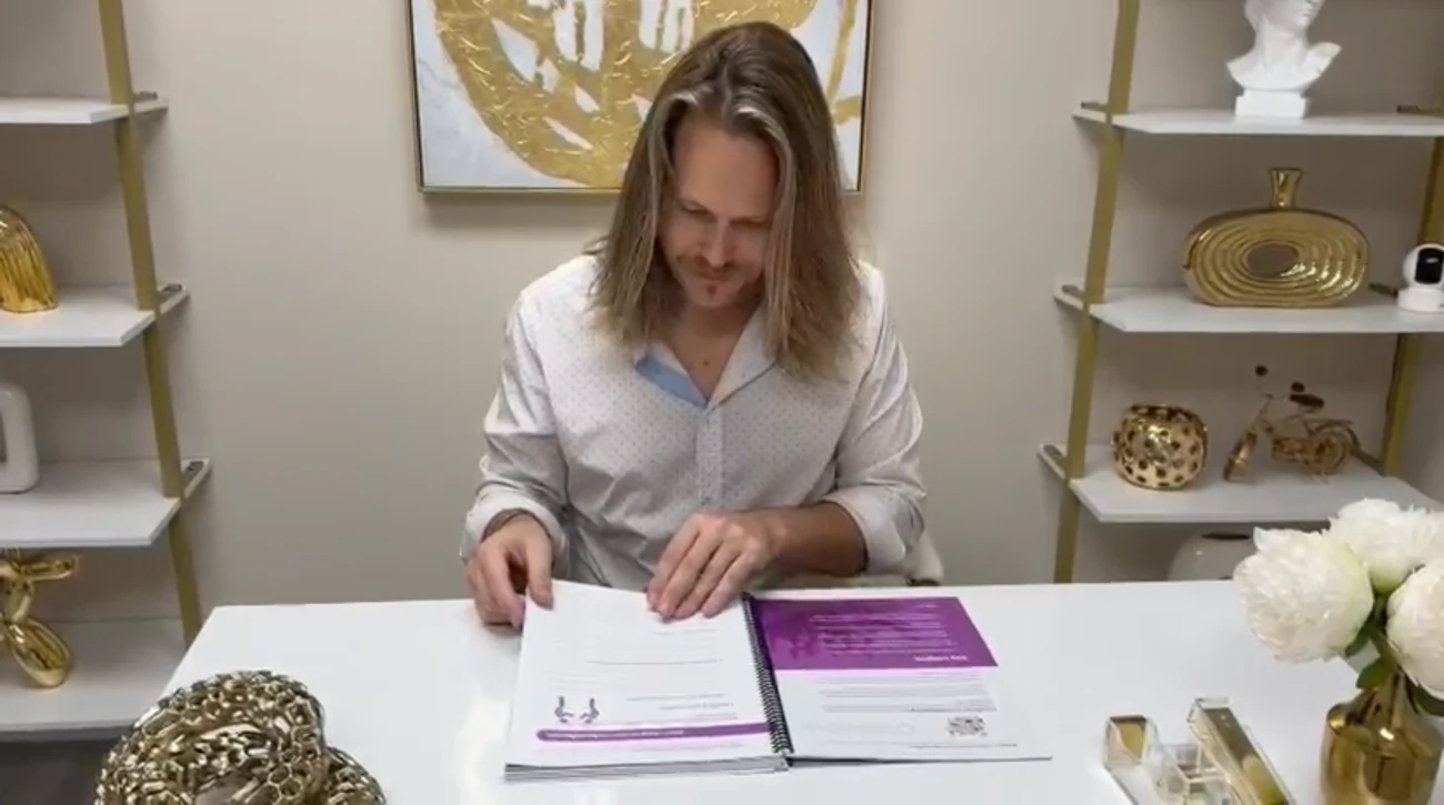 Jeff Parker Love signing a copy at his desk