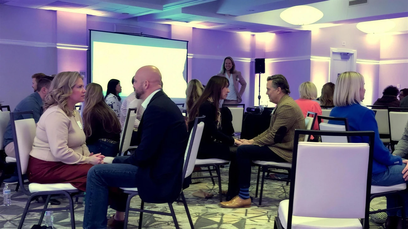 Couples sitting knee to knee, working through a conflict at one of Jeff's workshops