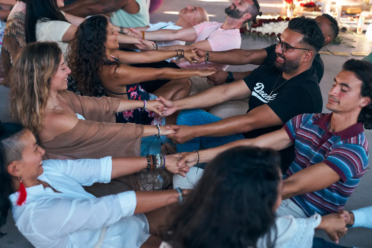 Rows of people reaching for each other's hands